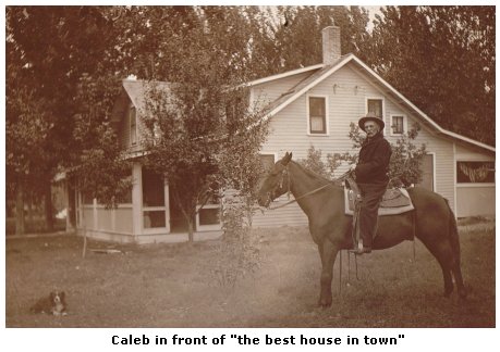 Caleb in front of "the best house in town"